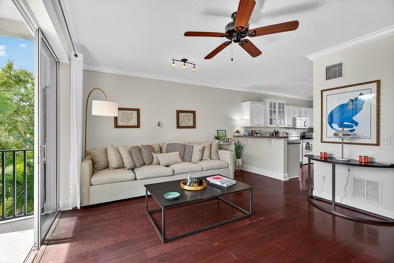 1685 42nd Square, Unit 101 Vero Beach, FL 32960 - Photo 11 of 37 a living room with furniture a rug and a window