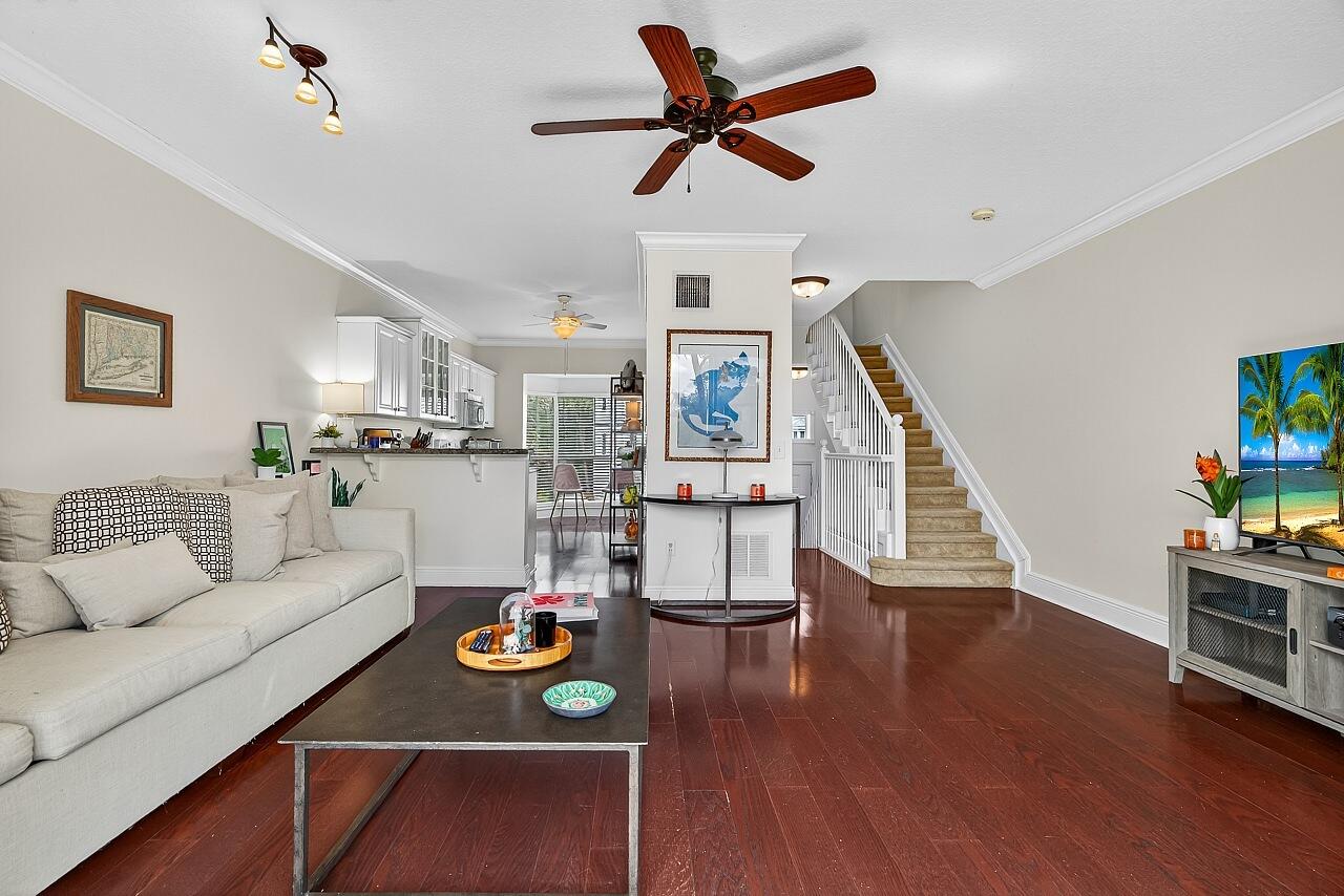 1685 42nd Square, Unit 101 Vero Beach, FL 32960 - Photo 12 of 37 a living room with furniture and kitchen view