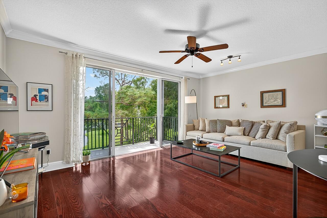1685 42nd Square, Unit 101 Vero Beach, FL 32960 - Photo 13 of 37 a living room with furniture and a large window