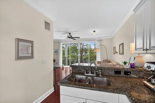a kitchen with granite countertop a sink and a counter top space