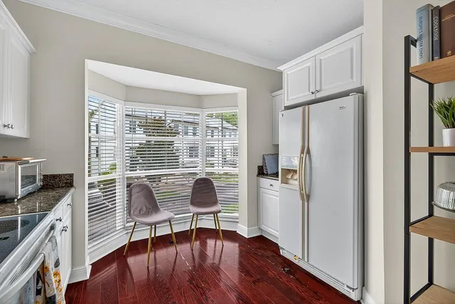 a view of a livingroom with furniture wooden floor and front door