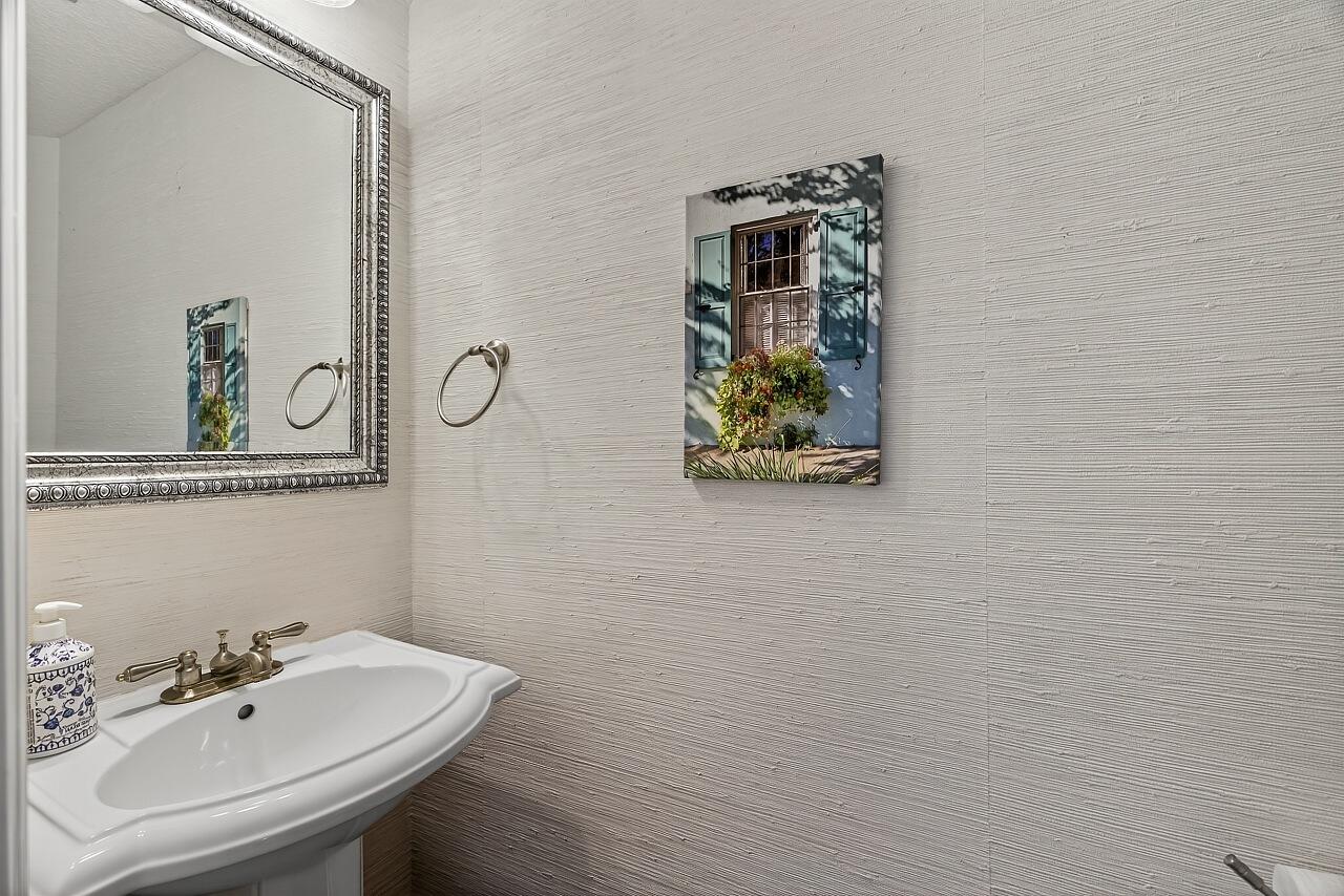 1685 42nd Square, Unit 101 Vero Beach, FL 32960 - Photo 18 of 37 a bathroom with a sink and a mirror