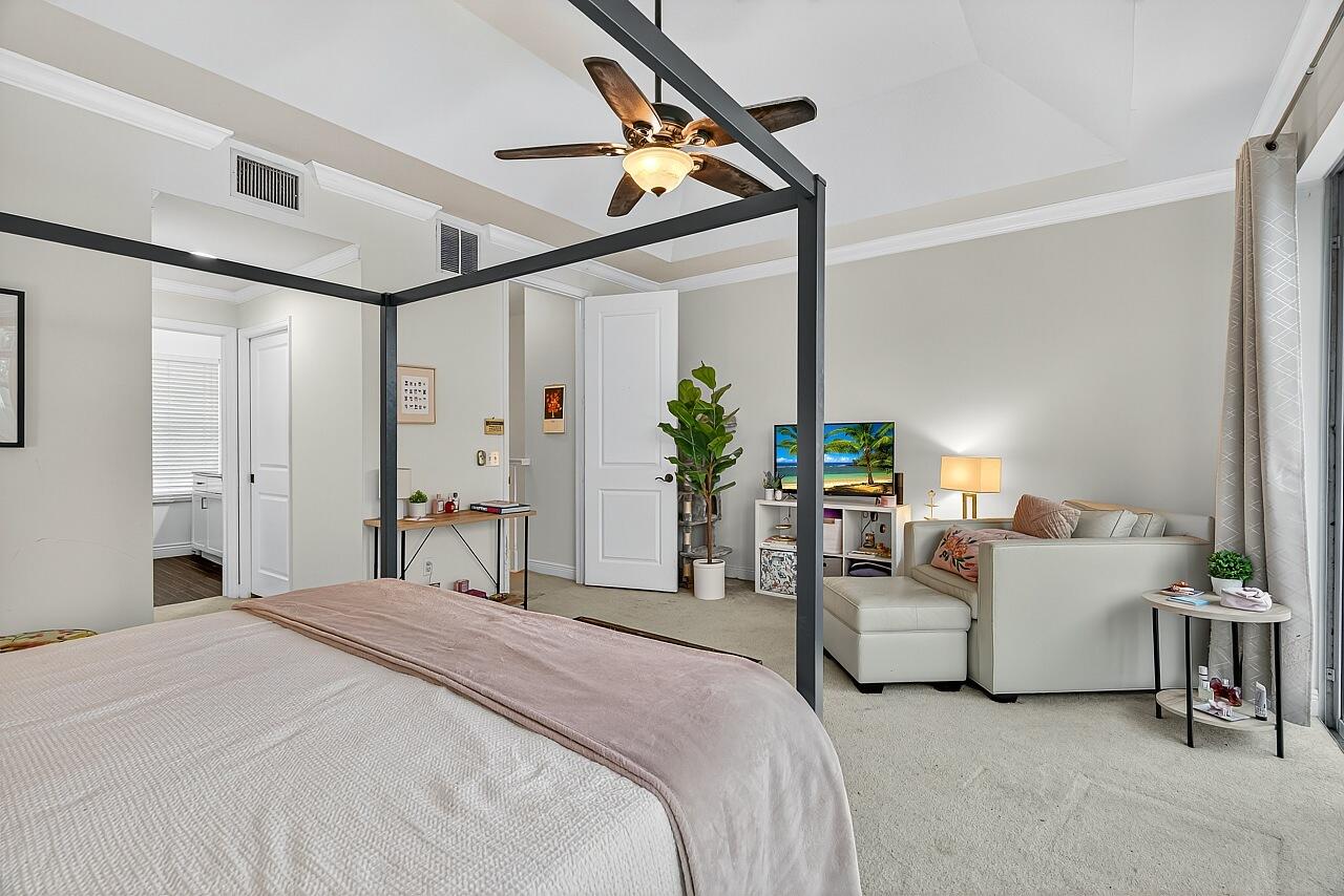 1685 42nd Square, Unit 101 Vero Beach, FL 32960 - Photo 20 of 37 a bedroom with bed and white cabinets