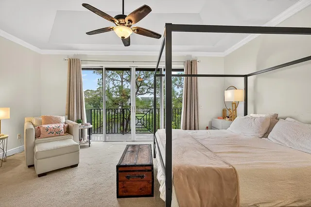 a bedroom with a bed couch and a large window