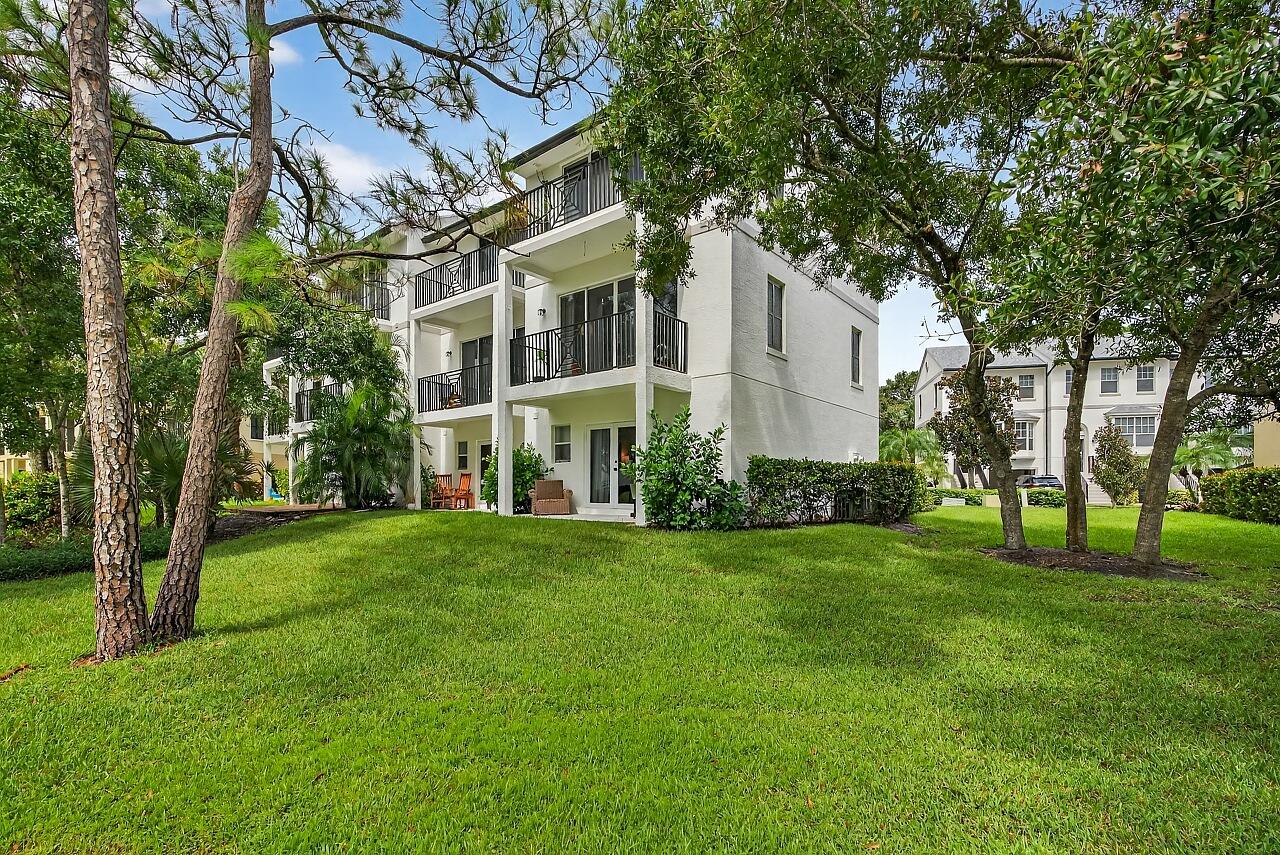 1685 42nd Square, Unit 101 Vero Beach, FL 32960 - Photo 24 of 37 a view of a big yard next to a house