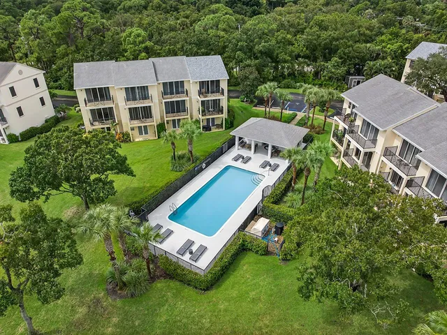 an aerial view of a house with a backyard