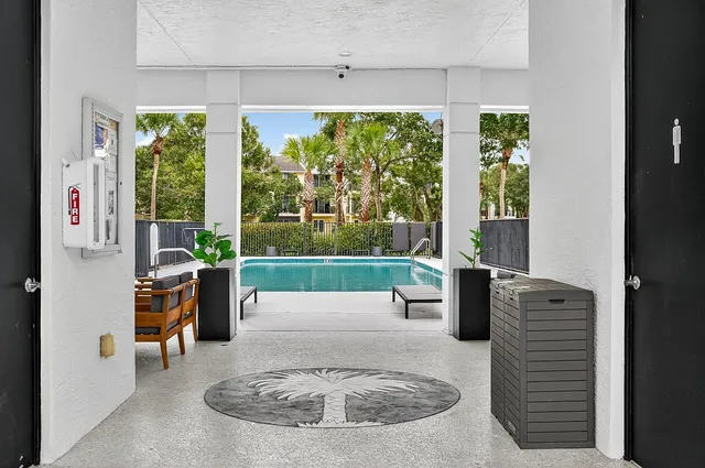 a living room with furniture and a floor to ceiling window