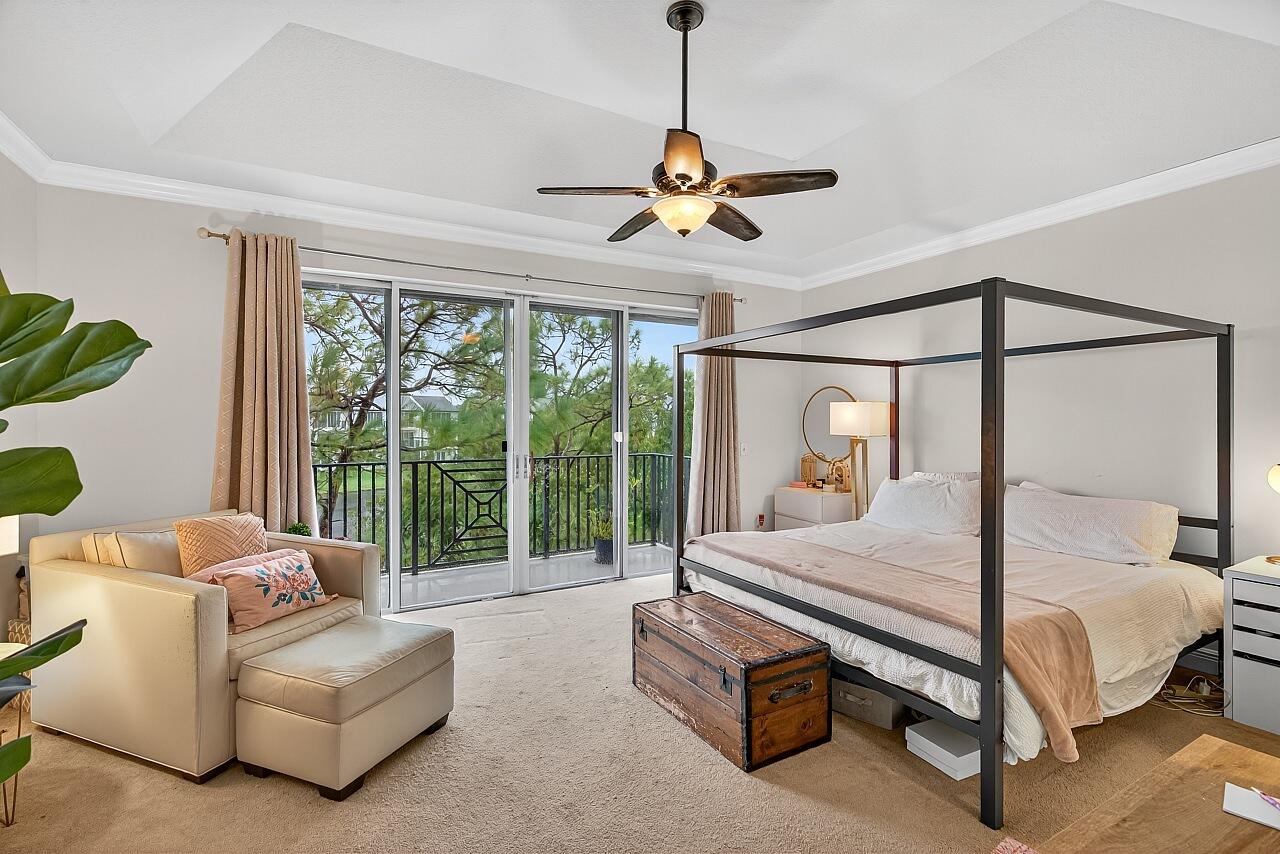 1685 42nd Square, Unit 101 Vero Beach, FL 32960 - Photo 3 of 37 a bedroom with a bed and a chandelier