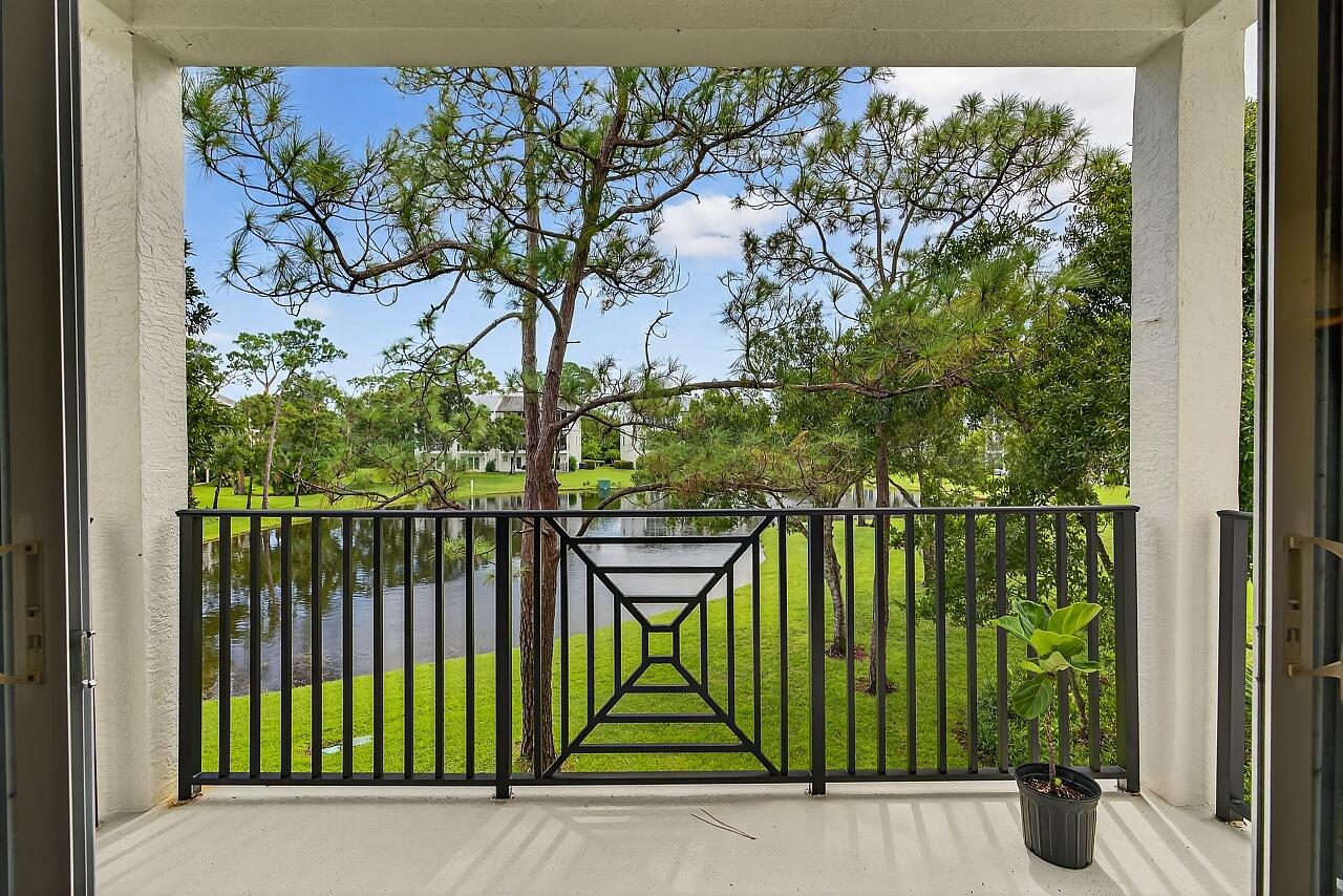 1685 42nd Square, Unit 101 Vero Beach, FL 32960 - Photo 7 of 37 a view of a balcony with a tree