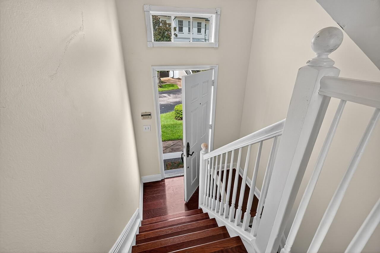 1685 42nd Square, Unit 101 Vero Beach, FL 32960 - Photo 10 of 37 a view of a hallway with wooden floor and entryway