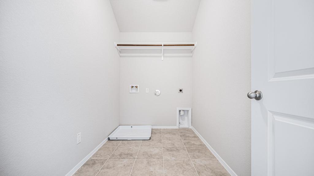 208 Stein Road Georgetown, TX 78626 - Photo 25 of 30 Washroom featuring hookup for an electric dryer, washer hookup, gas dryer hookup, and light tile patterned floors