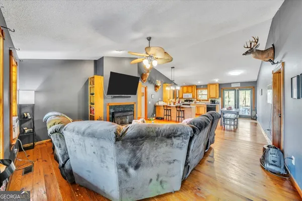 a living room with fireplace furniture and a flat screen tv