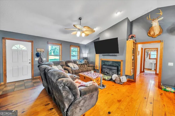 a living room with furniture and a wooden floor