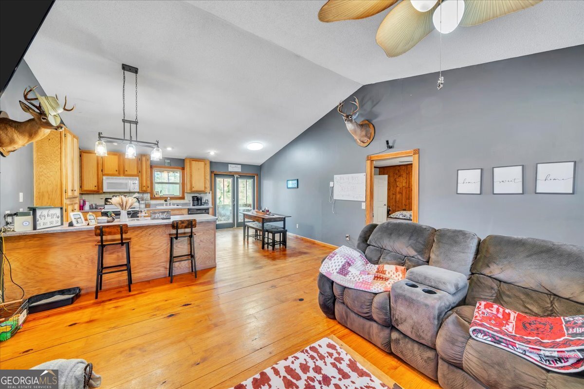 874 Mistletoe Road Abbeville, GA 31001 - Photo 17 of 67 a living room with furniture and a wooden floor