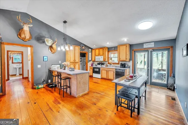 a view of a kitchen with dining table and a large window