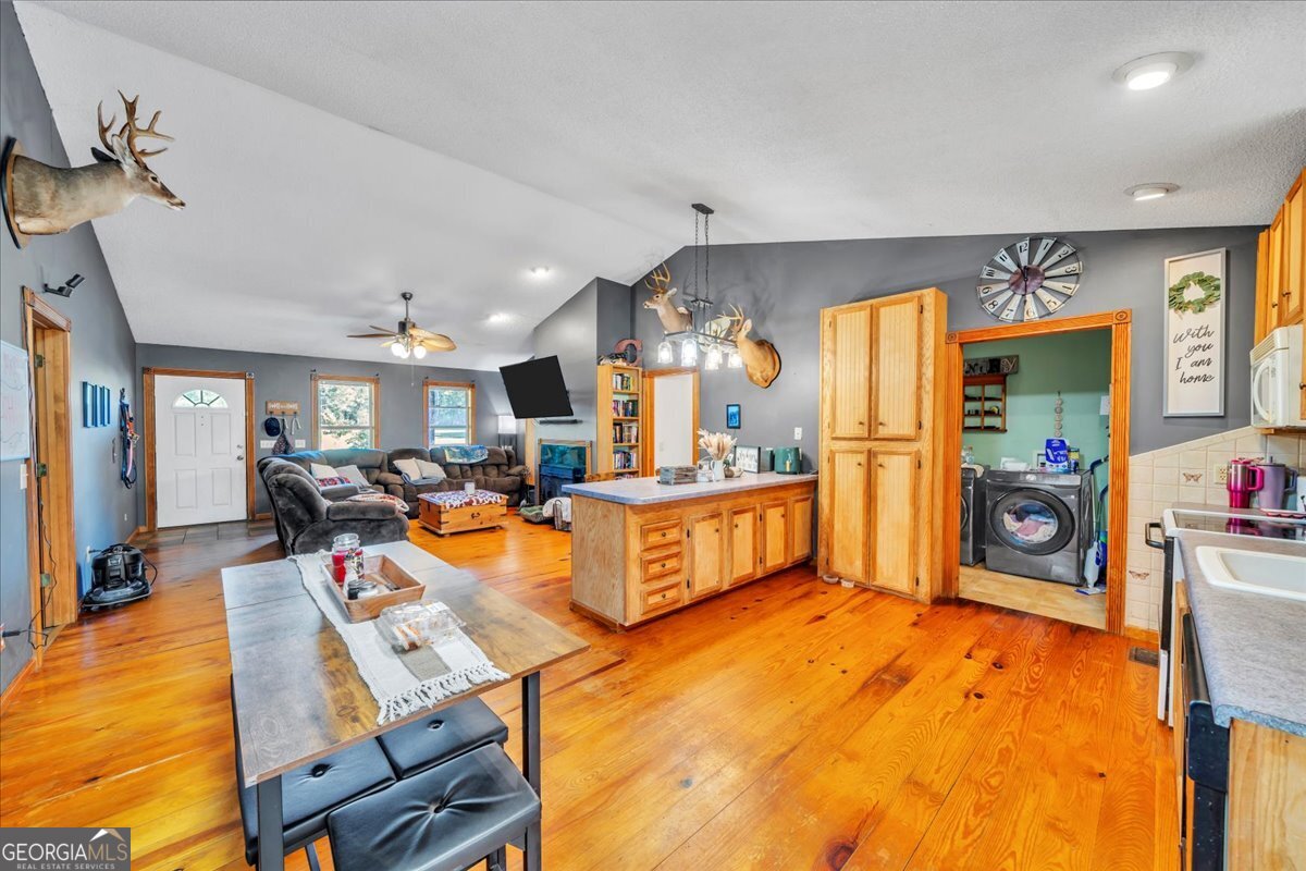 874 Mistletoe Road Abbeville, GA 31001 - Photo 20 of 67 a view of a kitchen with dining table and a large window