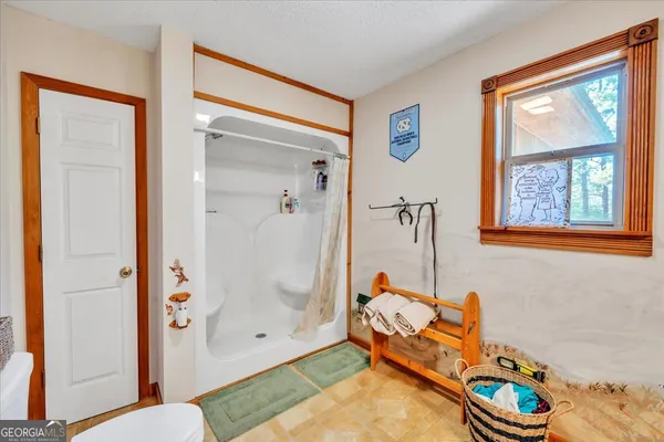 a bedroom with furniture and a window