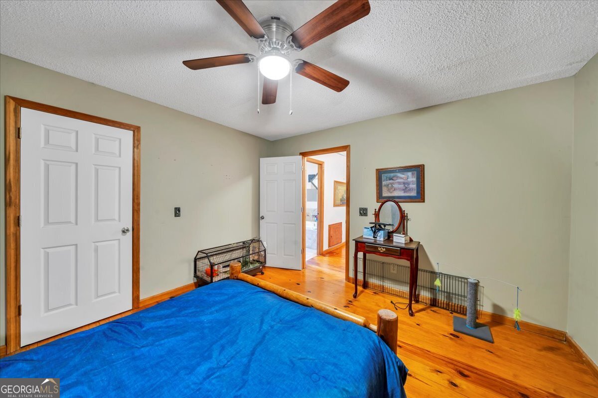 874 Mistletoe Road Abbeville, GA 31001 - Photo 32 of 67 a bedroom with a bed and a chandelier