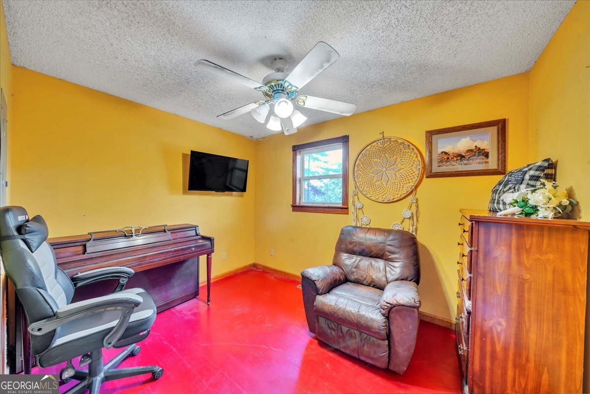 874 Mistletoe Road Abbeville, GA 31001 - Photo 35 of 67 a living room with furniture and a flat screen tv