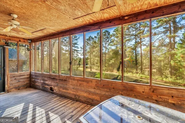 a view of a forest with an outdoor space and seating area