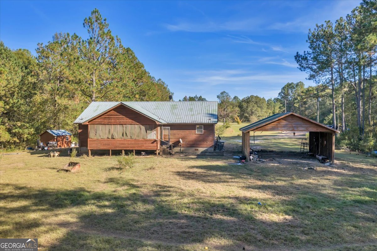 874 Mistletoe Road Abbeville, GA 31001 - Photo 10 of 67 a view of a large house with a big yard and large tree