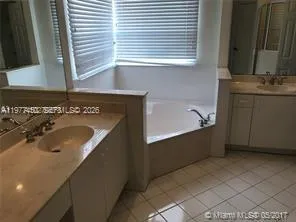 a bathroom with a granite countertop toilet sink and shower