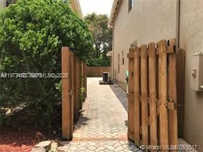 a view of a pathway with a wrought fence