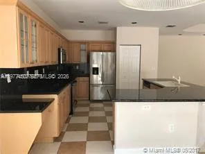 a kitchen with stainless steel appliances granite countertop a refrigerator and a stove