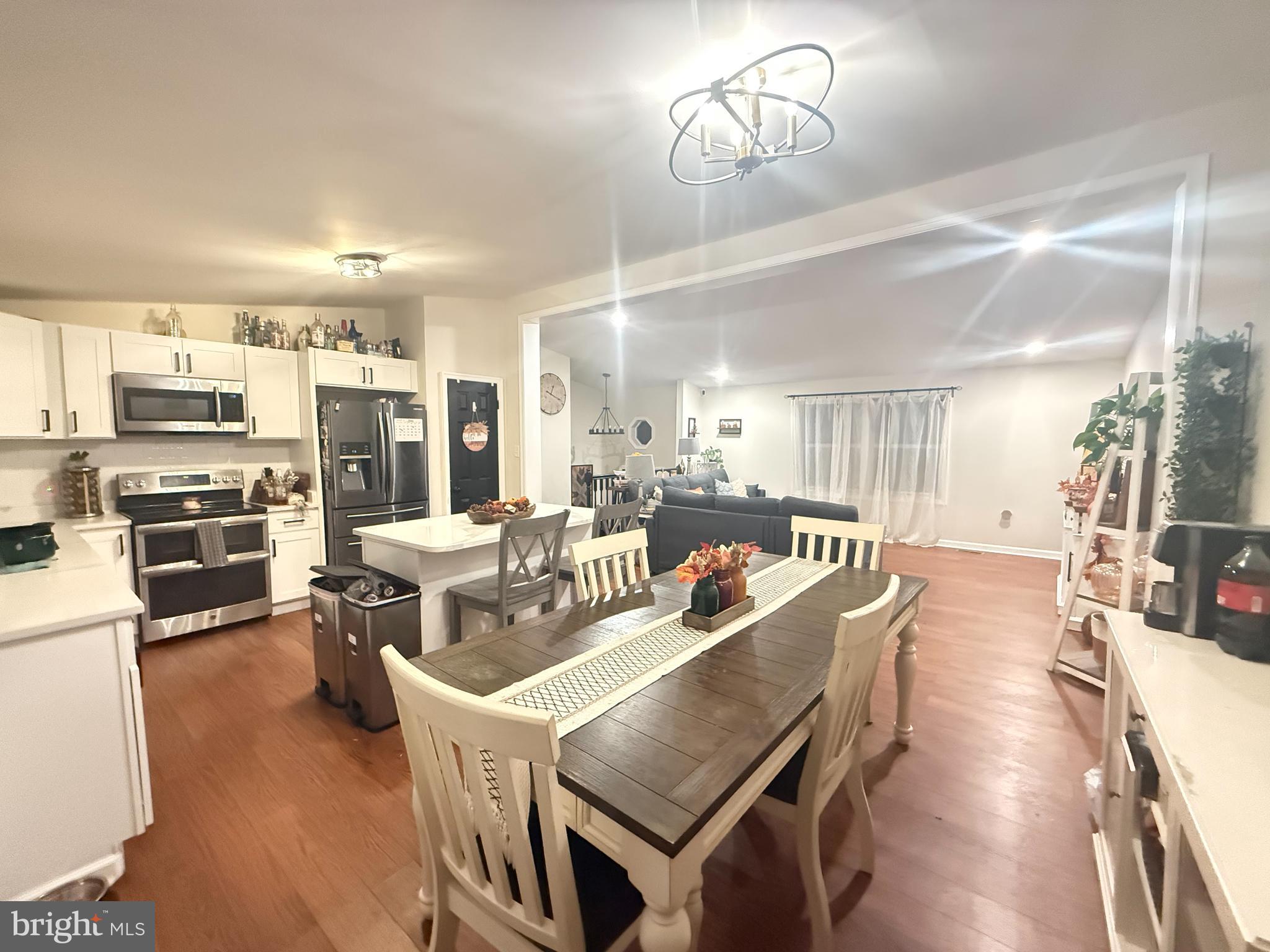 77 Martin Road Conowingo, MD 21918 - Photo 4 of 24 a living room with stainless steel appliances kitchen island granite countertop furniture a rug kitchen view and a chandelier
