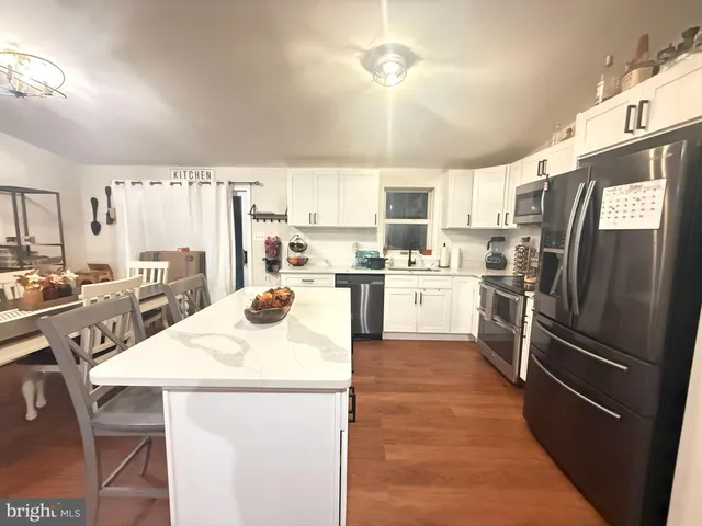 a kitchen with refrigerator a sink and cabinets