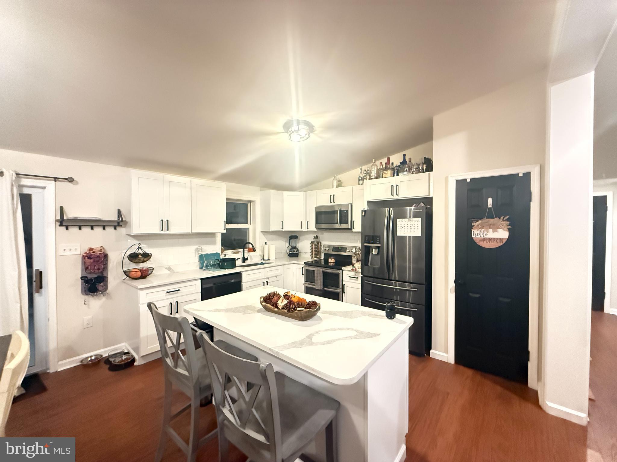 77 Martin Road Conowingo, MD 21918 - Photo 6 of 24 a kitchen with a refrigerator a stove a sink and a refrigerator with wooden floor