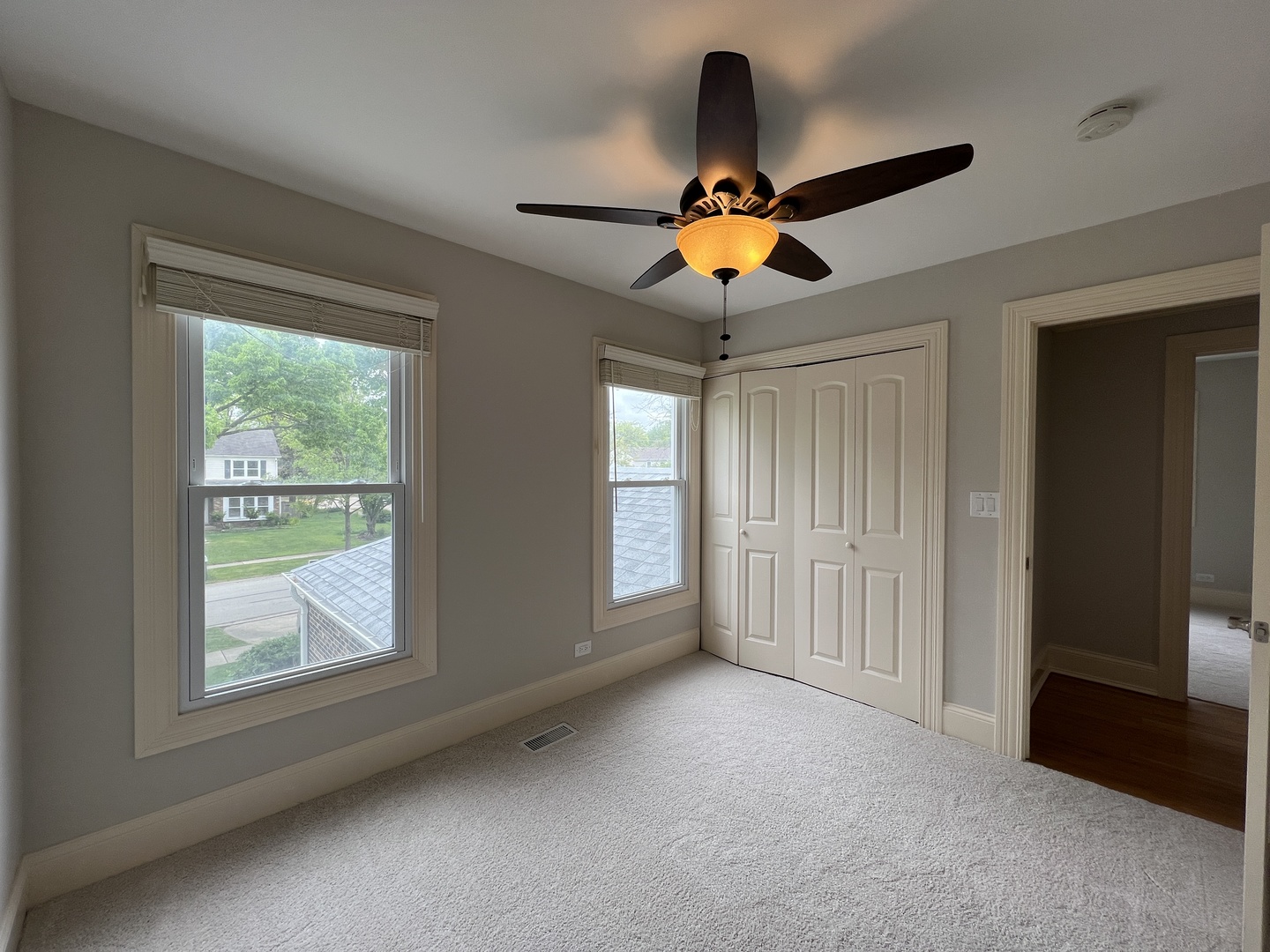 1108 Devonshire Road Buffalo Grove, IL 60089 - Photo 16 of 22 an empty room with windows and ceiling fan