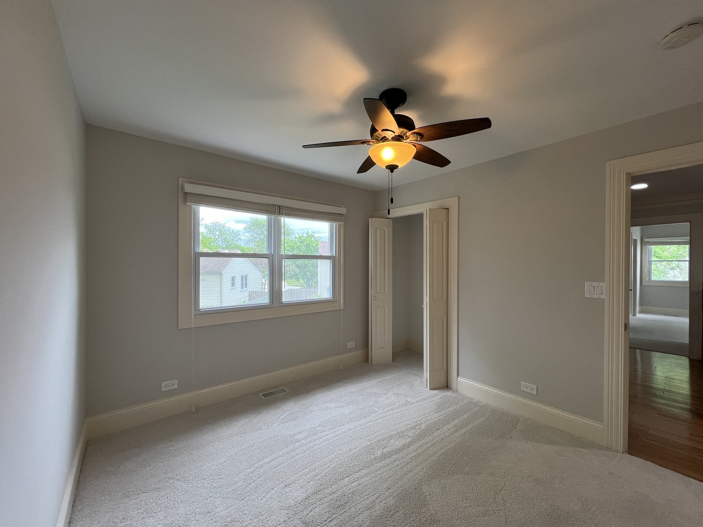 1108 Devonshire Road Buffalo Grove, IL 60089 - Photo 18 of 22 an empty room with a ceiling fan and window