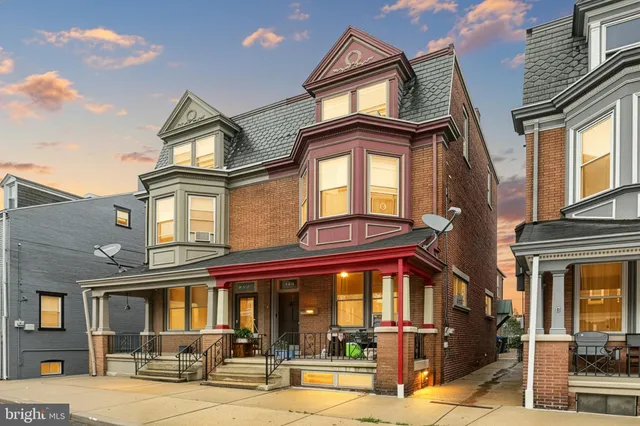 a front view of a residential apartment building with a yard