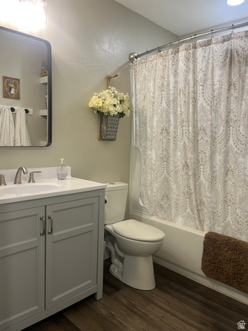 558 North N Cres Road Roosevelt, UT 84066 - Photo 16 of 31 Bathroom featuring a modern gray vanity, white countertop with integrated sink, brushed nickel faucet, and wood-finish flooring