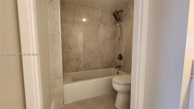 a bathroom with a bathtub and toilet