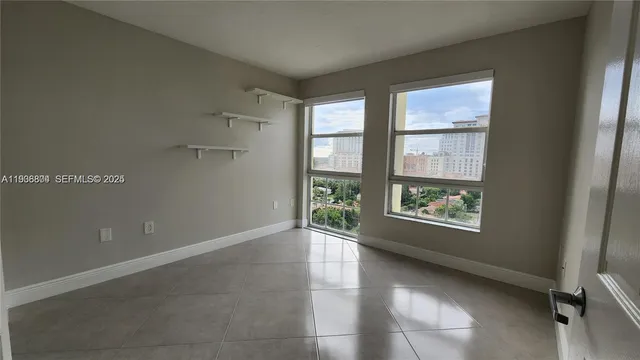 an empty room with windows and closet