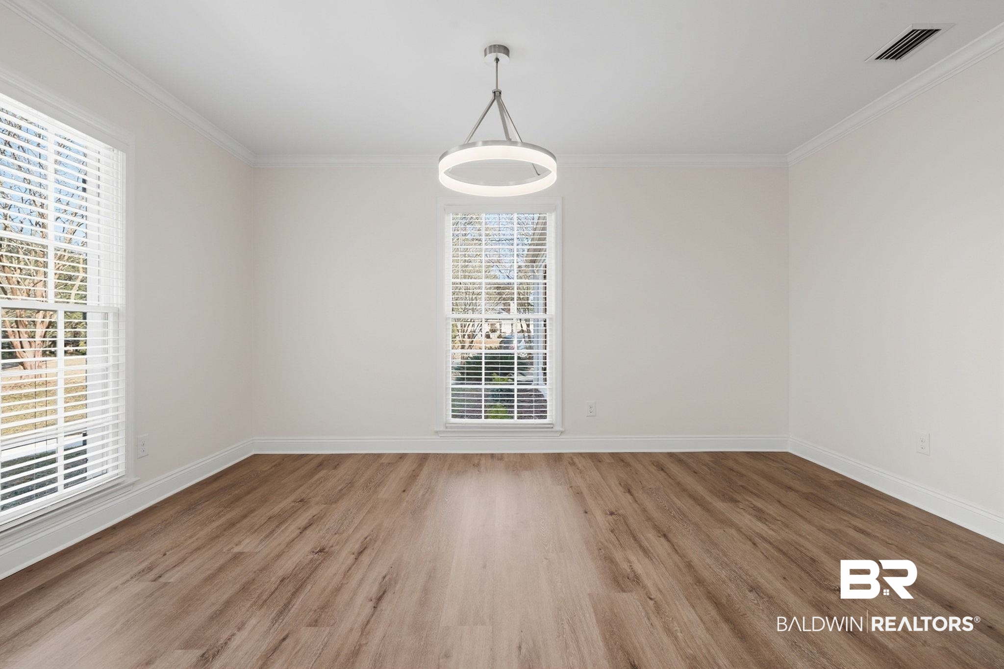 814 Nassau Drive Mobile, AL 36608 - Photo 15 of 44 Spare room with crown molding and wood finished floors