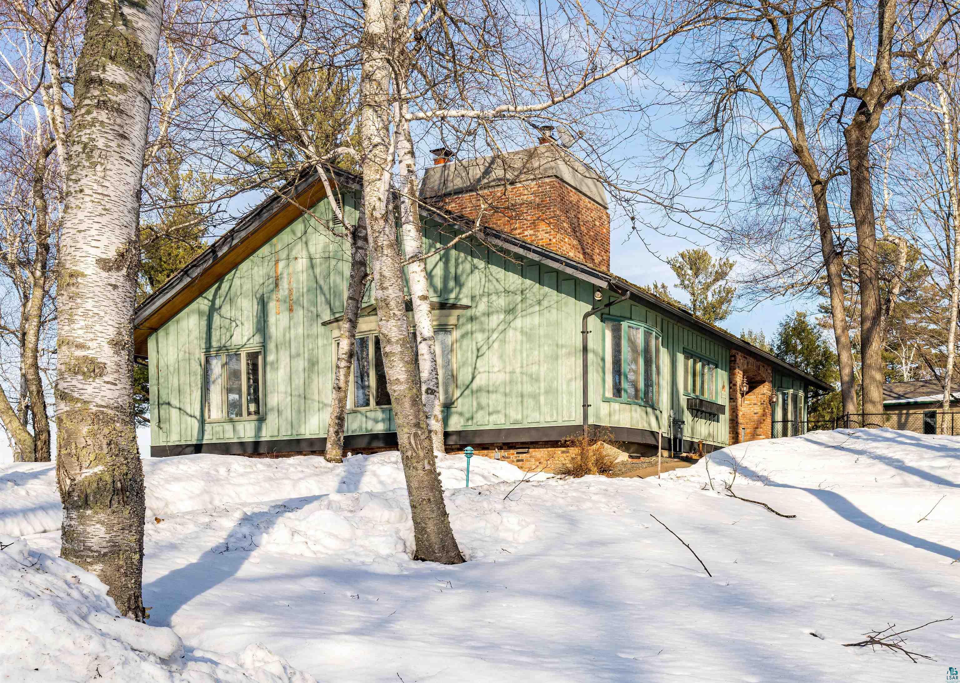 5781 South Pike Lake Road Duluth, MN 55811 - Photo 27 of 42 Snow covered property featuring a chimney