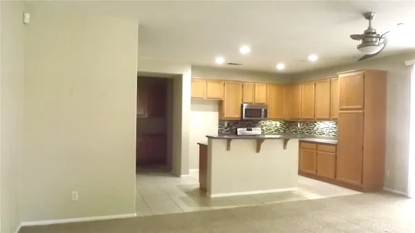 a kitchen with kitchen island a sink appliances and cabinets