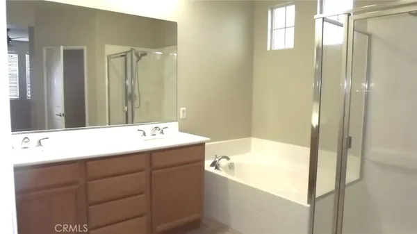 a bathroom with a bathtub sink and mirror