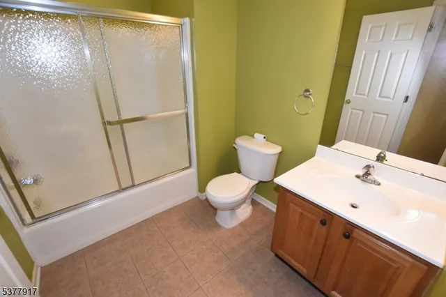 a bathroom with a toilet sink and a mirror
