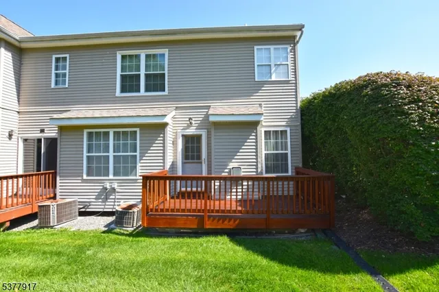 a view of a house with a yard and deck