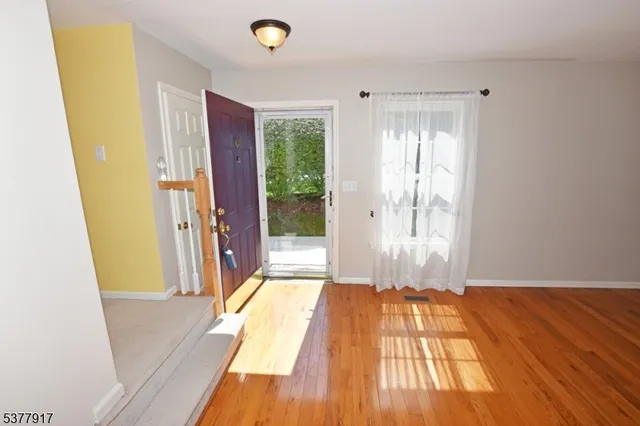 a view of outdoor space with wooden floor and windows