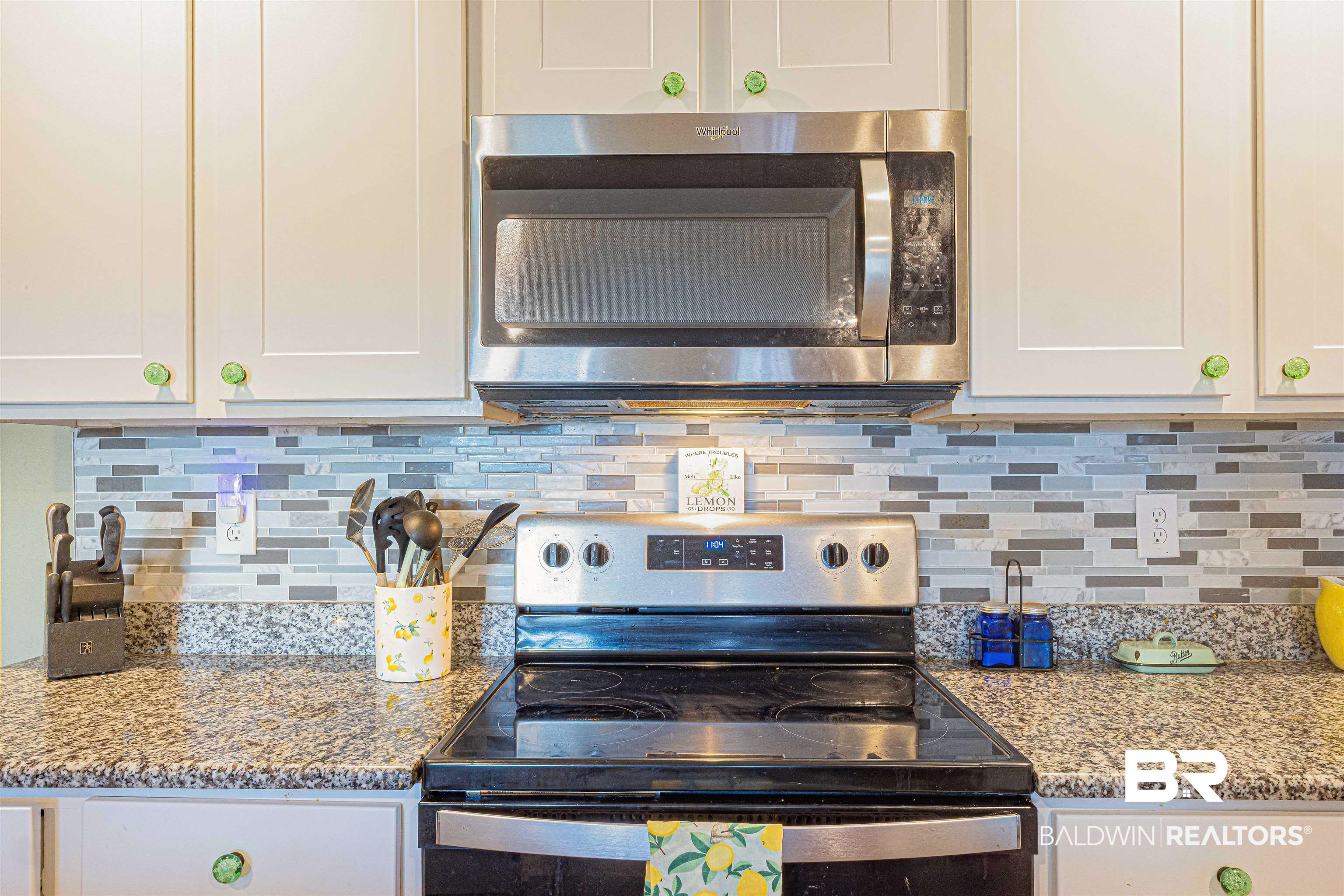 14843 Forsythia Loop Silverhill, AL 36576 - Photo 16 of 51 Kitchen with stainless steel appliances, light stone countertops, white cabinets, and tasteful backsplash