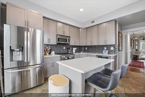 a kitchen with a stove a sink and a refrigerator
