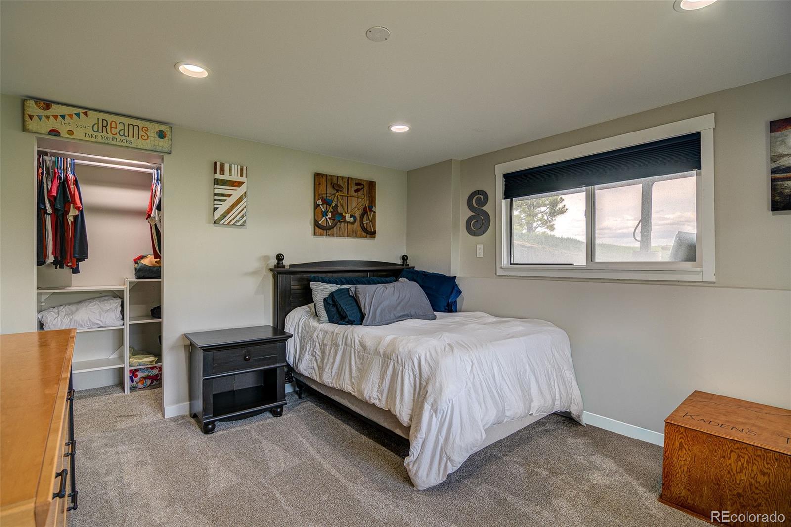 4531 East Best Road Larkspur, CO 80118 - Photo 25 of 49 a bedroom with a bed wall painting and a window