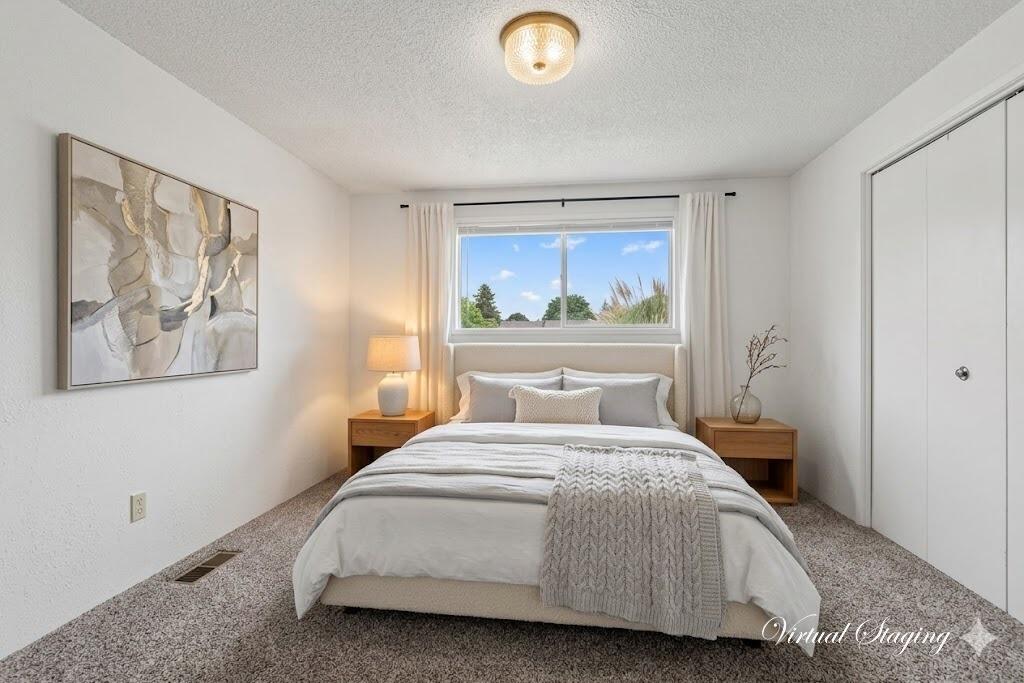 415 Sutter Avenue Medford, OR 97504 - Photo 14 of 28 a bedroom with a bed and a painting on the wall