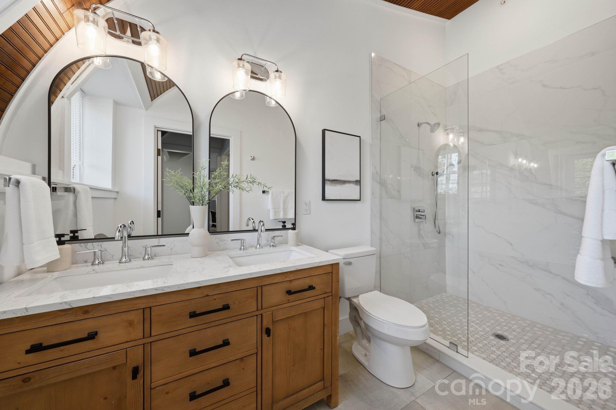 201 Grandin Road, Unit 13 Charlotte, NC 28208 - Photo 20 of 46 a spacious bathroom with a granite countertop sink a toilet and a mirror