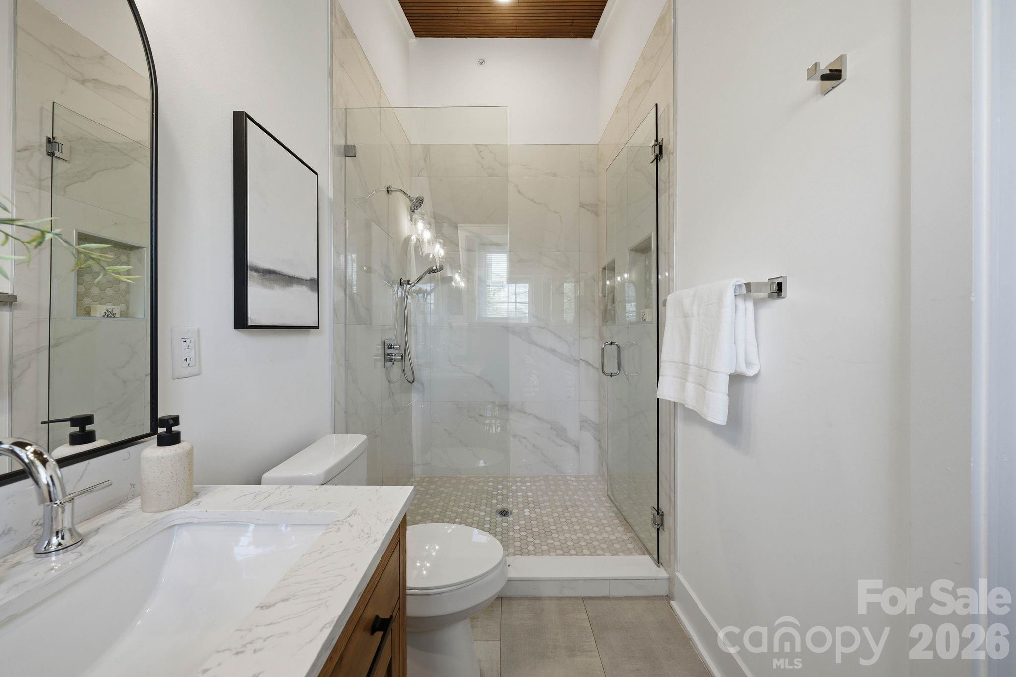 201 Grandin Road, Unit 13 Charlotte, NC 28208 - Photo 21 of 46 a bathroom with a granite countertop sink toilet and shower